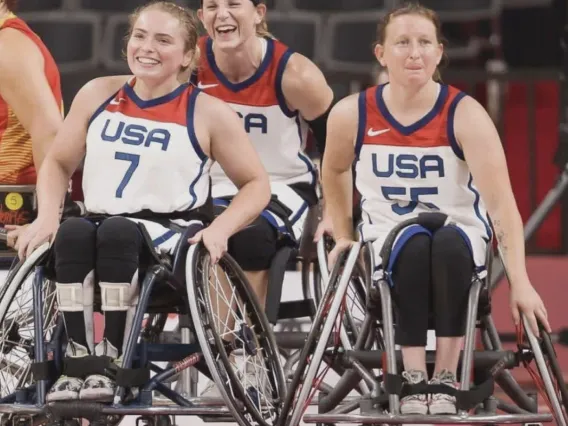 Paralympians Natalie Schnieder, Josie Aslakson, Courtney Ryan playing wheelchair basketball with USA jerseys