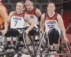 Paralympians Natalie Schnieder, Josie Aslakson, Courtney Ryan playing wheelchair basketball with USA jerseys